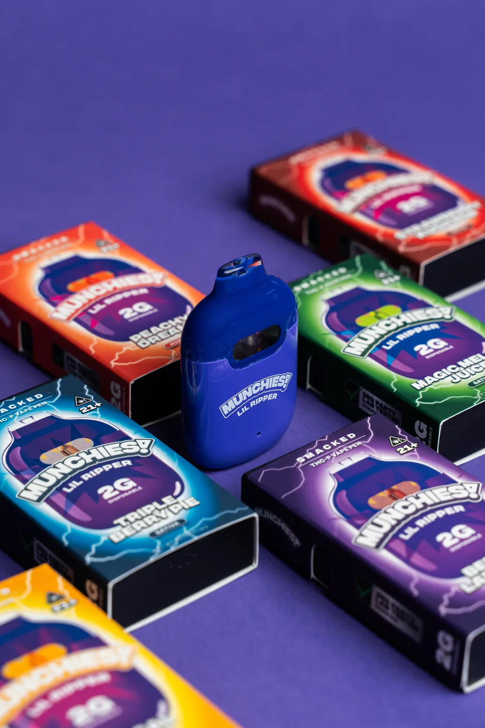 Lil Ripper device standing among Smacked flavor boxes